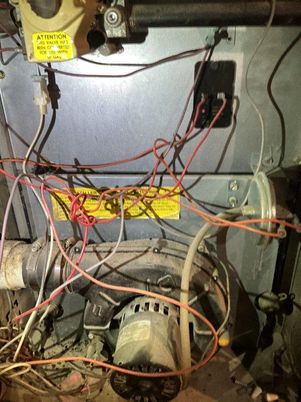Diagnosed two aging furnaces: a 31-year-old Goodman with a cracked heat exchanger and a 39-year-old Trane with intermittent shutdown issues and an inducer making noise. Inspection revealed 3 ppm carbon monoxide leak from the Trane unit. Both systems had abandoned boiler coils still attached despite boiler removal. Recommended replacement options due to the cracked heat exchanger and unavailability of Trane replacement parts.