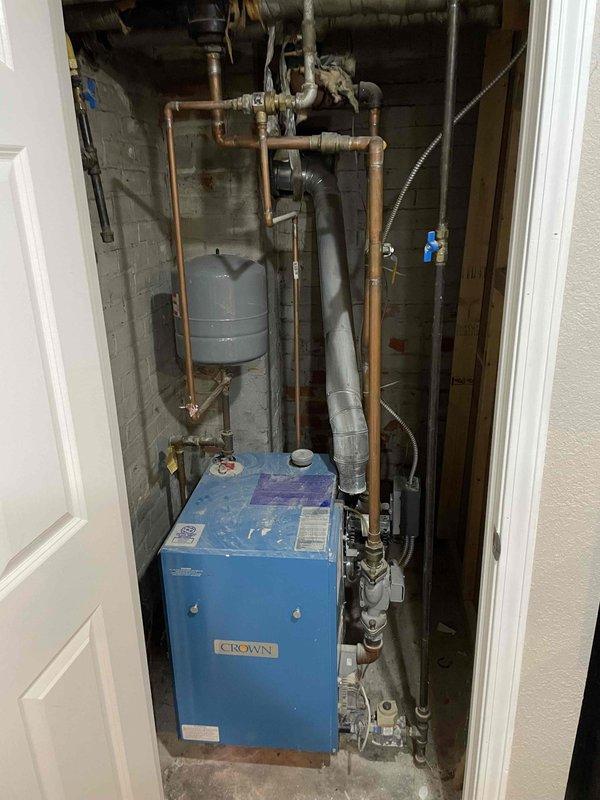Performed scheduled maintenance on 26-year-old Crown boiler. Cleaned burners and burner chamber, inspected all routine components, and verified proper operation of system including expansion tank and associated copper piping. No deficiencies found; discussed potential future updates including mini-split installation for AC/heat with customer.