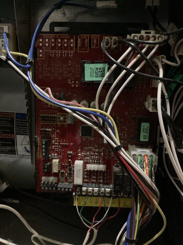 Responded to no-heat call on a 2020 Goodman gas furnace. Diagnosed control board failure as evidenced by erratic display showing nonsense characters and periodic blank screen. Board was non-responsive to thermostat calls and direct jumper testing despite proper voltage supply. Removed defective control board and installed new replacement board, restoring normal heating operation.