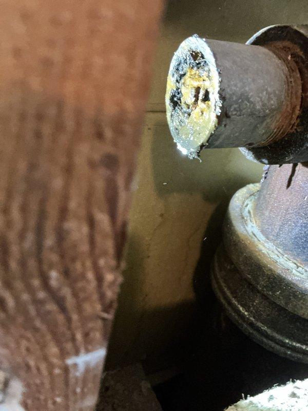 Responded to a water leak issue where the bathroom sink drain was leaking into the basement. Upon inspection, found severely corroded galvanized drain pipe with significant mineral buildup and deterioration. Created access through the wall, removed the damaged section, and installed new drain line components to resolve the leak.