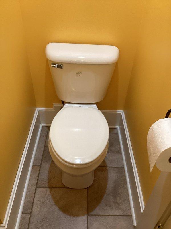 Responded to service call for toilet with spontaneous flushing and handle issues. Diagnosed and replaced defective flush seal that was causing water to leak from tank to bowl, triggering unnecessary refill cycles and engaging pressure pump. Installed new components and verified proper operation with complete flush cycle no longer requiring extended handle hold.