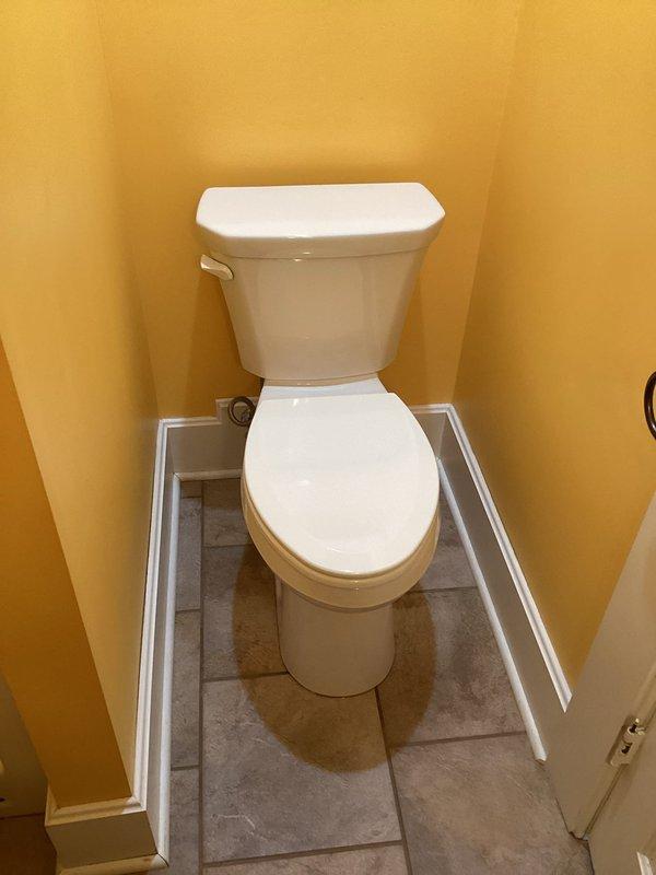 Responded to service call for toilet with spontaneous flushing and handle issues. Diagnosed and replaced defective flush seal that was causing water to leak from tank to bowl, triggering unnecessary refill cycles and engaging pressure pump. Installed new components and verified proper operation with complete flush cycle no longer requiring extended handle hold.