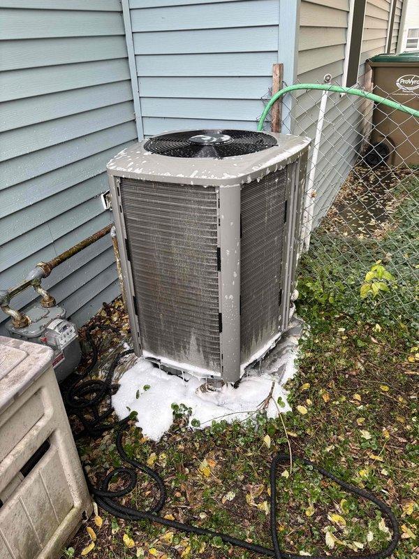 Performed annual Family Rewards furnace tune-up on 2-year-old system. Cleaned severely blocked heat pump condenser coils using pressure washer to restore proper airflow and efficiency. Replaced furnace filter and ran full diagnostics on S30 thermostat, noting potential flame sensor issue reading stuck at 2 which may require follow-up service.
