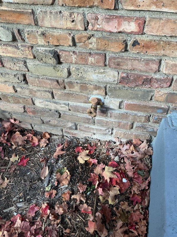 Returned to property to complete previously started work on exterior silcocks. Successfully installed proper fastening screws to secure two outdoor spigots to brick wall as required. Both silcocks now properly mounted and functional for inspection.
