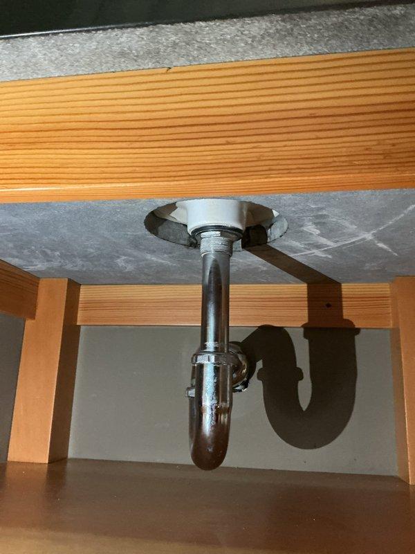 Responded to service call for sink leak in bathroom. Determined issue was a leaking drain strainer and replaced necessary washers to resolve. Also removed copper gas line and installed flex line for dryer connection. Customer was informed about city inspection requirements after gas line modification.