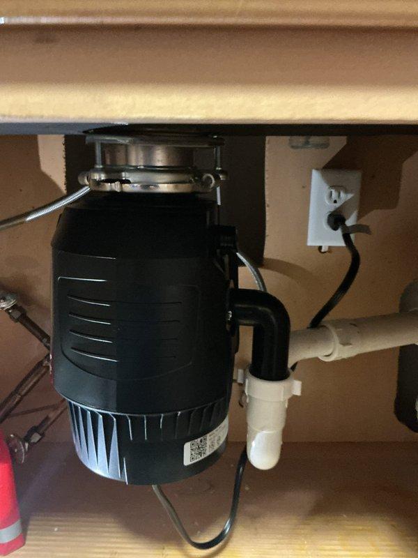 Replaced failing garbage disposal with new 3/4 HP unit. Diagnosed and resolved kitchen sink backup issues by blow bagging drain line. Installation completed successfully with proper drain connections.