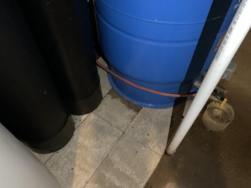 Conducted recurring plumbing inspection of residential water treatment system. Examined water heater, water softener unit, dual black water treatment tanks with pressure gauges, and Water Worker expansion tank. All components and associated PVC piping and water lines appear to be functioning properly with no visible leaks or irregularities noted.