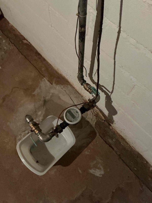 Responded to customer location to address leak at water meter inside the home. After city water department performed scheduled shutoff, replaced failed fittings at the meter that were originally installed during city's service line replacement approximately one year ago. Successfully restored water service with new professional-grade shut-off valve and fittings, eliminating the leak at the meter connection.