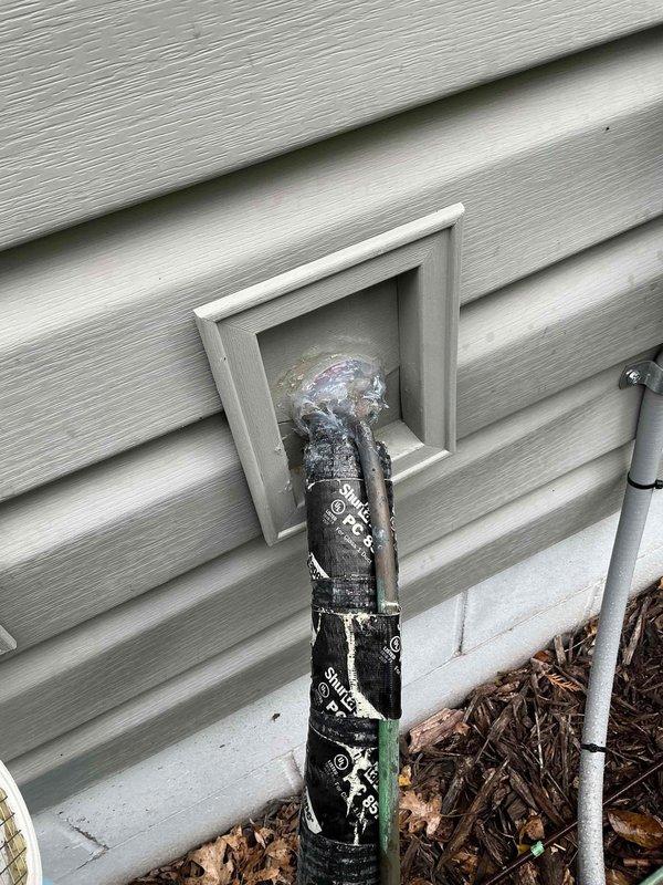 Responded to warranty callback for HVAC system installed within the past year. Customer reported deteriorated exterior seal around line set penetration, which was confirmed upon inspection with visible damage to the insulation and potential entry points for moisture or pests. Successfully resealed the line set penetration with a generous application of silicone to ensure complete closure and prevent future water intrusion or pest access.