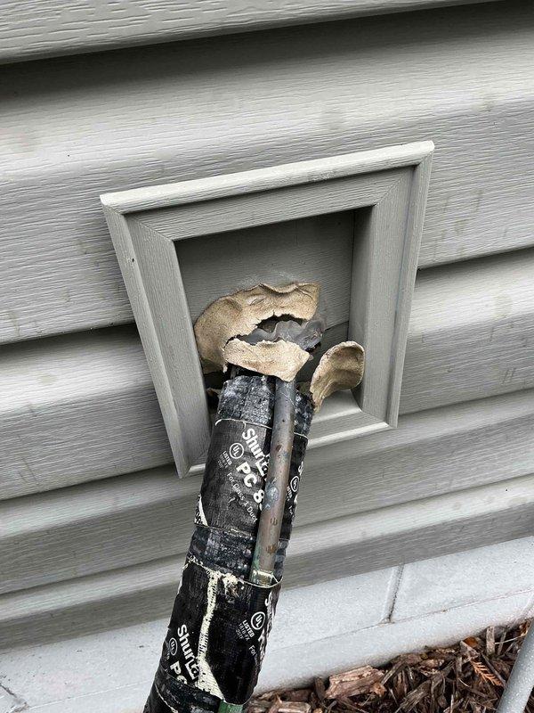 Responded to warranty callback for HVAC system installed within the past year. Customer reported deteriorated exterior seal around line set penetration, which was confirmed upon inspection with visible damage to the insulation and potential entry points for moisture or pests. Successfully resealed the line set penetration with a generous application of silicone to ensure complete closure and prevent future water intrusion or pest access.