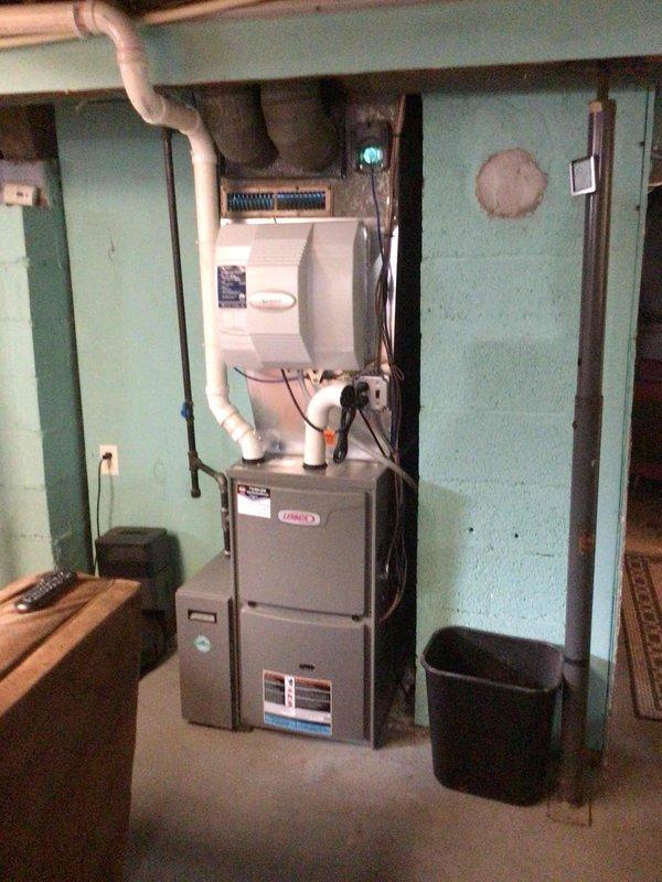 Performed annual furnace tune-up on Lennox unit. Found and cleared clogged elbow fitting in AC drain pan, resolving reported water leakage issue. Replaced UV bulb and filter (customer-provided), verified electrical components within specification, cleaned flame sensor, and cleared all drain hoses. Unit operating properly after service.