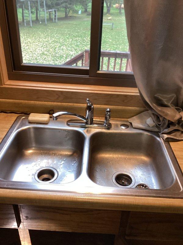 Responded to service call for kitchen sink clog and faucet leak. Performed drain snaking procedure to remove food waste blocking kitchen drain pipe (customer noted grandson disposed food incorrectly thinking disposal was present). Replaced faulty kitchen faucet to resolve persistent dripping issue.