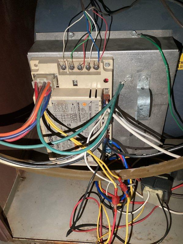 Responded to no-heat service call on a 30-year-old furnace with extensive cabinet rust. Diagnosed system failure with no proper ignition sequence when tested with jumper wires. Noted immediate red light termination and continuous blower operation. Observed water-damaged manual and significant corrosion around blower motor assembly and control board. Provided free estimate for replacement.