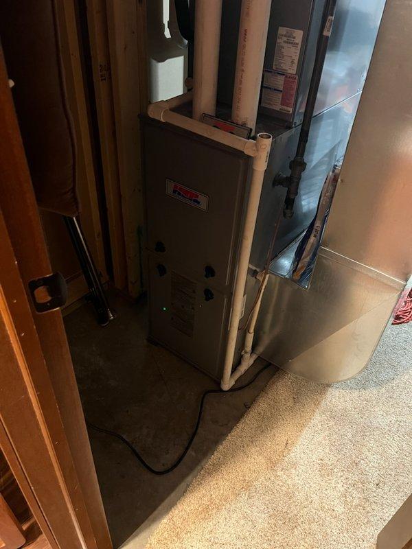 Responded to a no heat call for a 10-year-old furnace. Diagnosed a flame sensor reading out of specification and a gas valve receiving 27V but failing to open. Demonstrated the system malfunction to homeowner Tom using a contactor to visually confirm voltage supply to the gas valve. Completed a comprehensive tune-up of the furnace components and discussed replacement options with the customer.