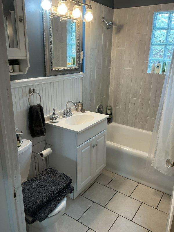 Responded to service call for clogged bathroom sink and tub drains in upper unit. Upon inspection, discovered significant corrosion and mineral buildup in the sink drain area causing the blockage. Despite standard drain clearing procedures, was unable to fully restore proper drainage due to the extent of deterioration in the drain system.