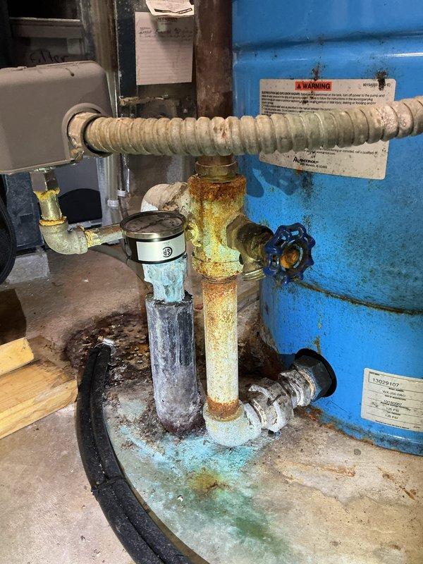 Responded to service call for loose faucet issue. Performed maintenance by tightening handle and cleaning the faucet assembly. Also inspected water heater system and associated plumbing components, noting corrosion on vertical pipe and mineral buildup requiring future attention.