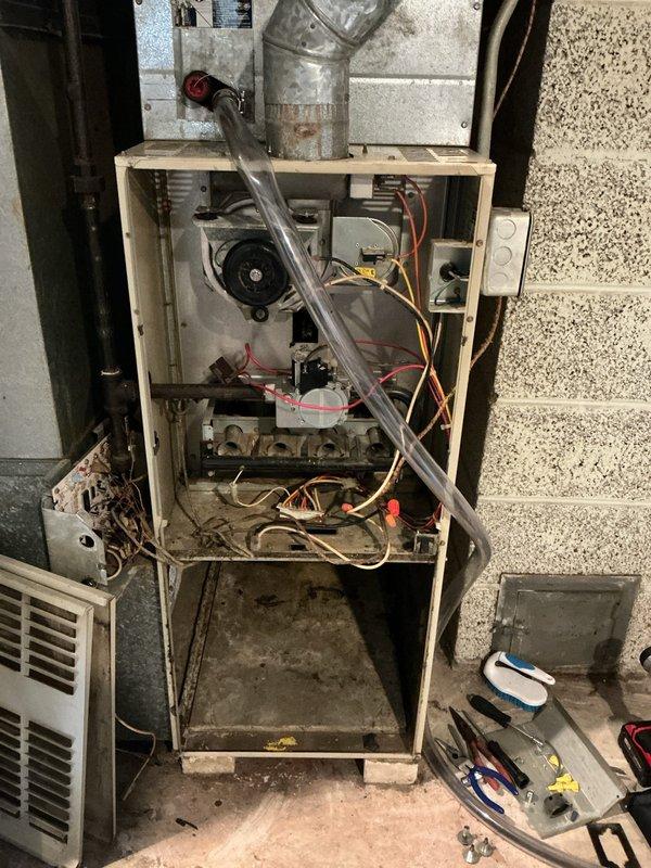Responded to no-heat service call for aging furnace system. Upon inspection, discovered severely cracked heat exchanger and seized blower motor rod that prevented successful motor replacement. Provided customer with replacement options and scheduled follow-up sales consultation to discuss system replacement recommendations due to safety concerns.
