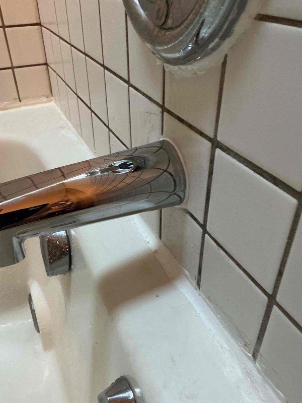 Addressed customer concern regarding tub spout installation that was protruding 1/4-1/2 inch from wall. Repositioned and secured the previously installed chrome tub spout to sit flush against the tiled bathroom wall, ensuring proper fit and function.