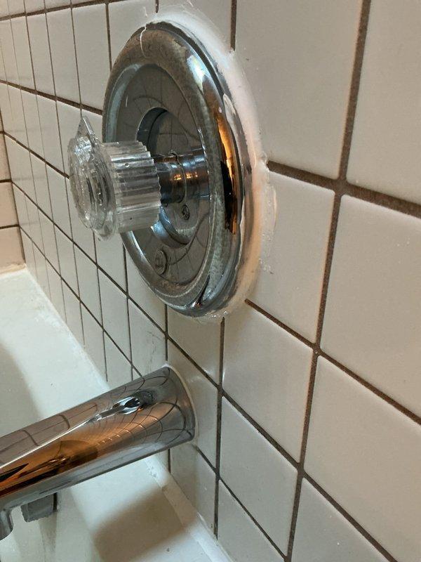 Addressed customer concern regarding tub spout installation that was protruding 1/4-1/2 inch from wall. Repositioned and secured the previously installed chrome tub spout to sit flush against the tiled bathroom wall, ensuring proper fit and function.