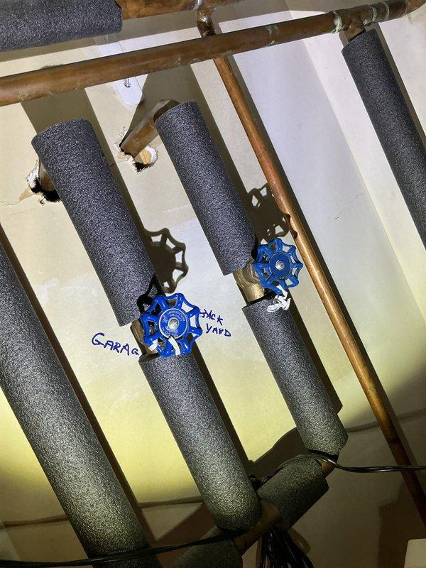 Replaced two malfunctioning outdoor water spigots and installed two new hose bib shutoff valves to resolve leaking issues. Upgraded the garage hose bib with a new unit, featuring proper insulation on supply lines and blue handled shutoff valves with appropriate labeling for improved functionality and accessibility.