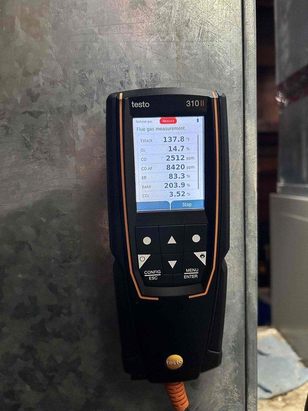 Performed furnace tune-up on FRP unit of undetermined age. Discovered critical safety issues including cracked heat exchanger, significant soot buildup inside heat exchanger, mold accumulation on components, and a stuck inducer motor. Upon testing, unit produced extremely dangerous CO levels exceeding 3,000 ppm as verified with Testo analyzer. Red-tagged furnace as unsafe for operation and recommended replacement options.