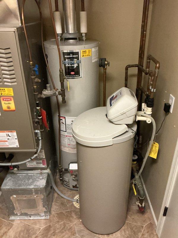 Performed comprehensive plumbing inspection of residential mechanical room containing water heater, water softener system, and related plumbing infrastructure. Removed utility sink from original location, capped the drain line, and temporarily relocated the sink to garage per customer request. Inspection coincided with separate electrical appointment scheduled by homeowner.