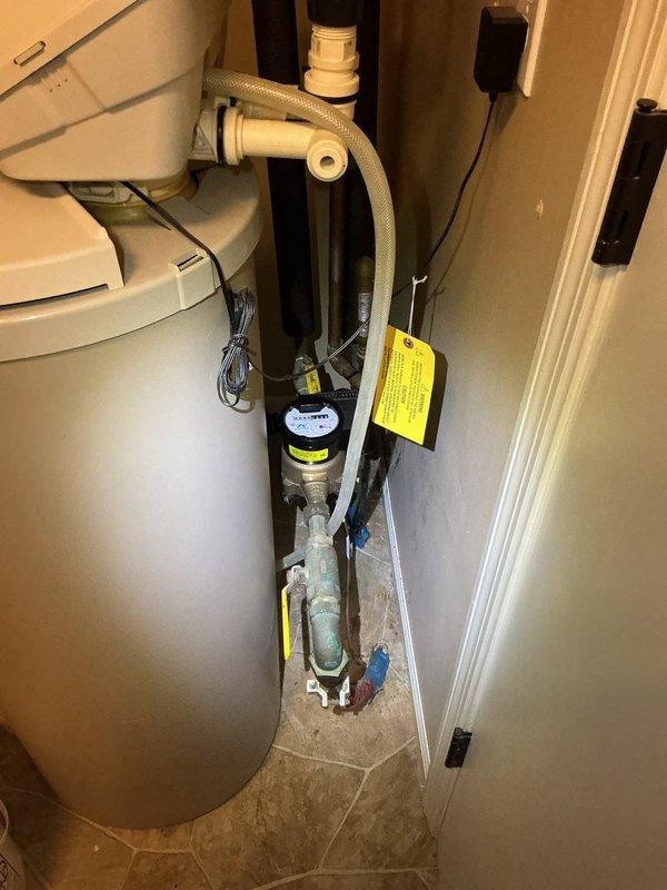 Performed comprehensive plumbing inspection of residential mechanical room containing water heater, water softener system, and related plumbing infrastructure. Removed utility sink from original location, capped the drain line, and temporarily relocated the sink to garage per customer request. Inspection coincided with separate electrical appointment scheduled by homeowner.
