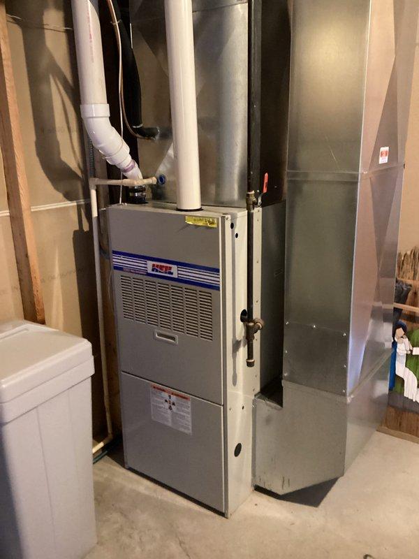 Performed comprehensive furnace tune-up on 20-year-old Heil unit. Inspected heat exchanger which showed concerning areas but no compromises detected. Identified blower wheel with excessive play and capacitor reading 7.1μF (below 10μF specification). Removed blower assembly to inspect secondary heat exchanger, finding no leaks. System operated normally during 20-minute test run with 45°F temperature rise. Recommended Furnace Replacement Program due to age and component condition.