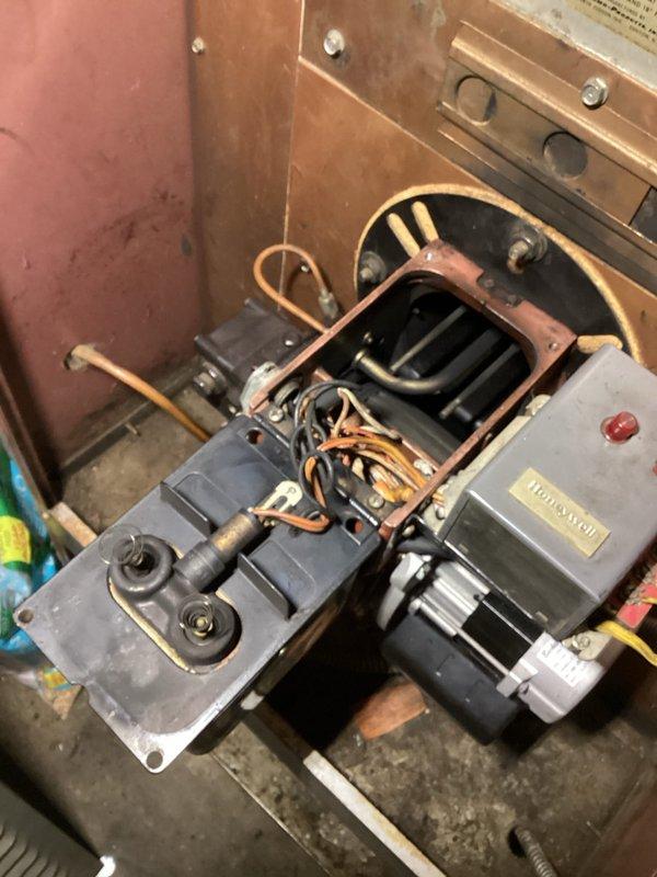 Responded to service call for oil furnace producing banging sounds during startup and oil odor. Diagnosed delayed ignition causing fuel accumulation and subsequent loud boom upon lighting. Identified poor contact between ignition rods and igniter as the root cause, performed thorough cleaning of connections and burner area. Also noted malfunctioning draft regulator not closing/operating properly. Successfully restored normal furnace operation and placed order for replacement draft regulator.