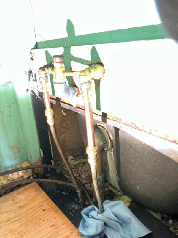 Repaired customer-damaged bathtub plumbing after hot water supply line was broken during DIY spout removal attempt. Found plastic SharkBite fitting broken in half, requiring immediate water shut-off. Removed damaged fitting and re-piped with new SharkBite fitting, pro adapter, and coupling to restore proper water flow.