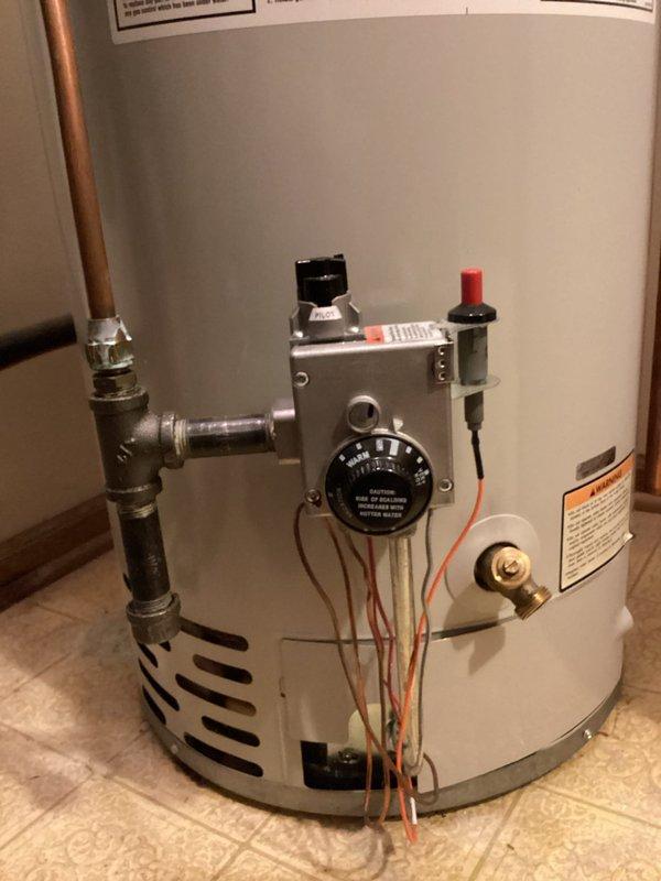 Diagnosed 21-year-old natural gas water heater with malfunctioning gas valve causing intermittent heating issues. Temporarily restored pilot light functionality, but advised customer that valve failure was imminent. Recommended and scheduled replacement of unit with new 40-gallon atmospheric water heater including installation of code-required disaster pan to prevent potential water damage to lower unit.