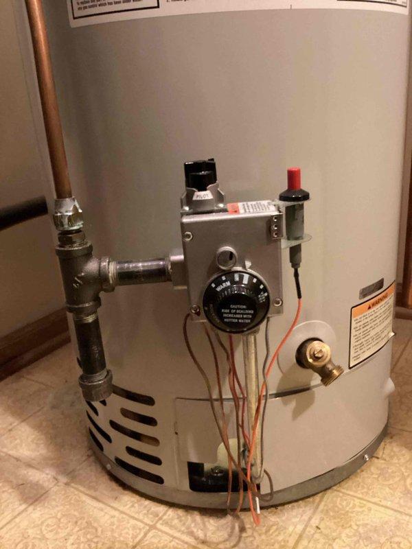 Diagnosed 21-year-old natural gas water heater with malfunctioning gas valve causing intermittent heating issues. Temporarily restored pilot light functionality, but advised customer that valve failure was imminent. Recommended and scheduled replacement of unit with new 40-gallon atmospheric water heater including installation of code-required disaster pan to prevent potential water damage to lower unit.