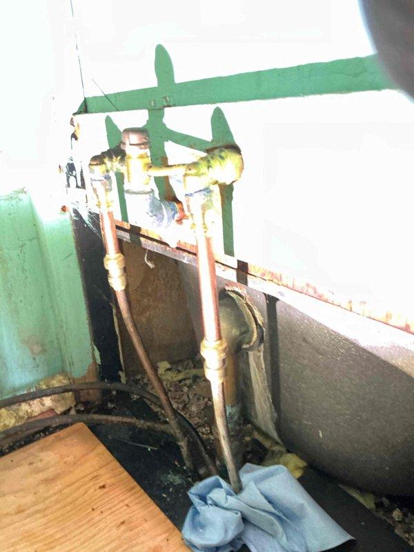 Repaired bathtub leak where customer damaged hot water supply line while attempting to remove spout. Shut off water supply, removed broken plastic SharkBite fitting and re-piped with new SharkBite fitting, professional adapter, and coupling to restore proper function.