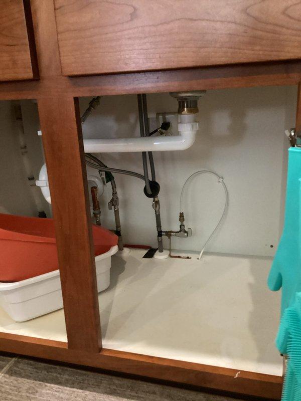 Inspected garbage disposal unit that was reported to be leaking. Removed existing disposal, bypassed the system, and installed a standard sink drain assembly with basket strainer to eliminate the disposal per customer request. Provided estimates for other reported plumbing issues including slow-flushing toilet, aging sump pump, leaking bathroom faucets, non-functioning sink stopper, kitchen faucet mobility issues, and water system contamination.