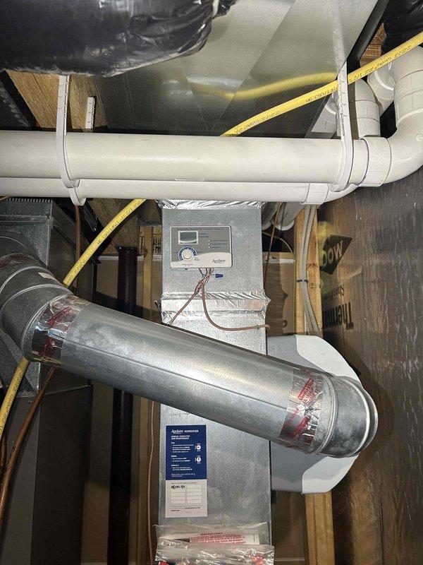 Performed comprehensive furnace tune-up on Lennox unit (approximately 10 years old). Identified significant rust and water leakage throughout top and bottom of furnace. Conducted carbon monoxide testing with acceptable PPM readings and verified proper gas pressure. Replaced air filter and humidifier panel, installed condensation trap on exhaust, and cleared condensation using CO2. System returned to functional condition despite corrosion issues.