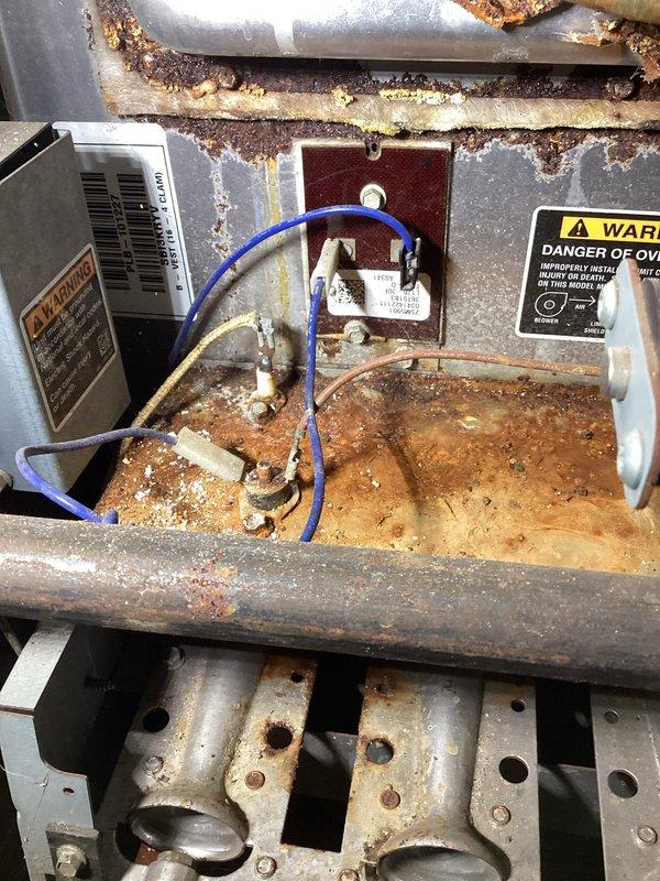 Responded to service call for 12-year-old NG furnace producing rattling noise and slight odor with limited heat output. Diagnostic inspection revealed non-functioning ignition system with failed ignitor, extensive rust damage to heat exchanger and burners, and corroded roll out switch preventing safe operation. Due to multiple critical component failures and advanced system age, recommended full system replacement and scheduled comfort advisor consultation.