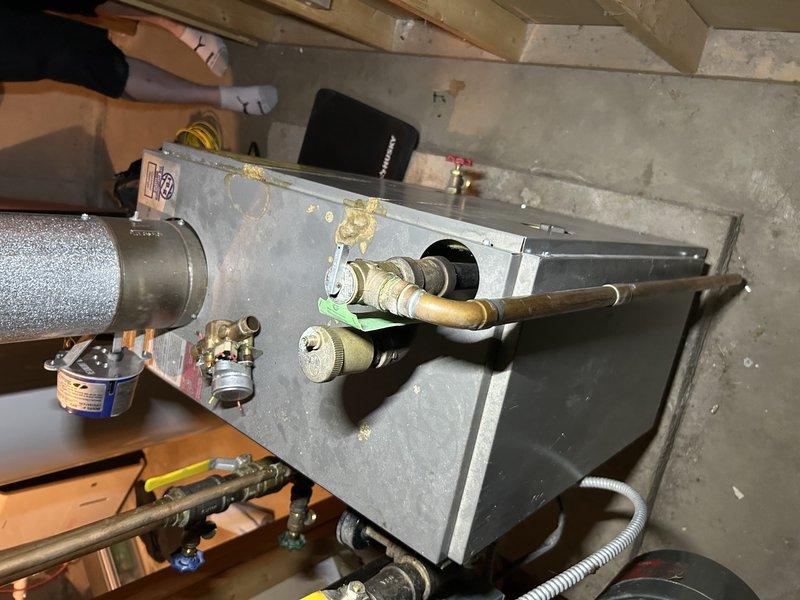 Responded to customer report of carbon monoxide detector activation during boiler operation. Performed diagnostic testing which revealed high CO readings. Inspection found dislodged flame retardant insulation on right burner disrupting proper combustion and causing sooting of heat exchanger. Temporarily repositioned insulation and verified improved but still elevated CO levels. Recommended heat exchanger cleaning service to fully resolve issue; scheduled follow-up appointment with appropriate equipment.