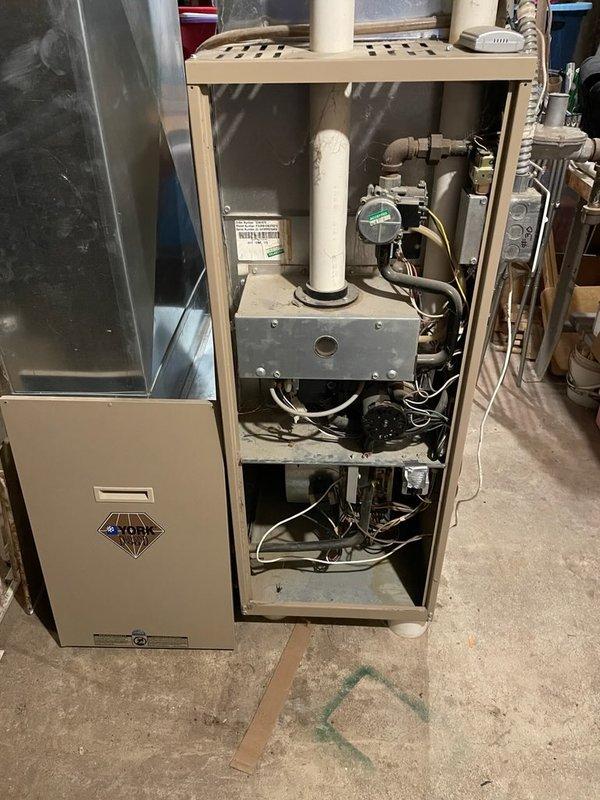 Diagnosed 22-year-old York furnace with no heat issue. Found inducer draft motor seized, running hot, and collector box cracked. Recommended replacement of both draft inducer motor and collector box due to age and condition of unit.
