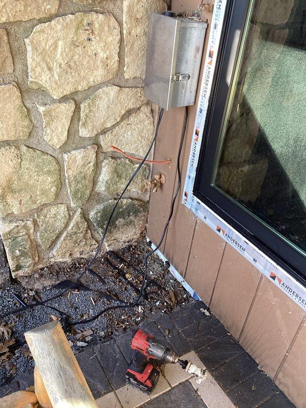 Installed new outdoor hose bibb by running an Apex water supply line from the basement's exposed joists to the exterior wall. Added a shutoff valve on the copper supply piping for serviceability and mounted the frost-free hose bibb through the stone facade exterior with appropriate waterproofing.