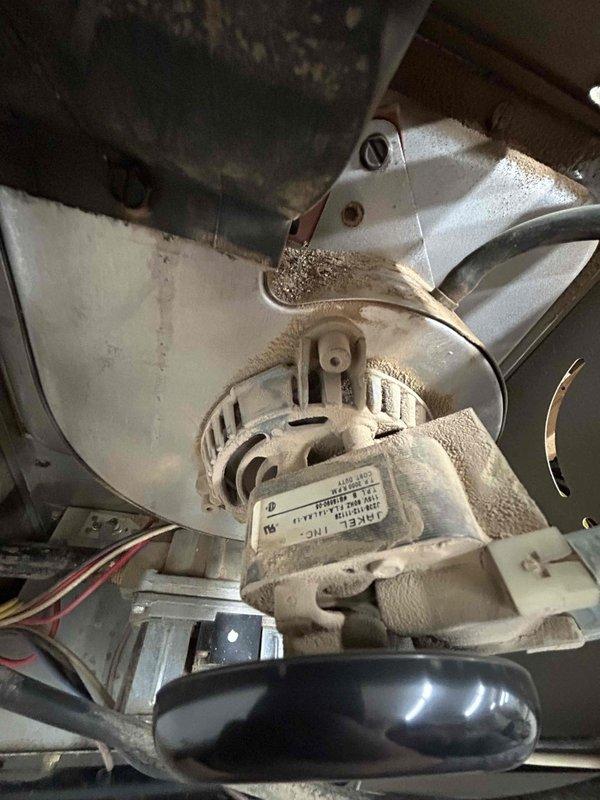 Responded to no-heat call for older furnace in workshop. Diagnosed tripped roll out switch, burnt wiring, and plugged burners. Cleaned affected burners, repaired damaged wires, and performed system test - unit now functioning properly. Noted high-pitched noise from inducer motor during operation which subsided.
