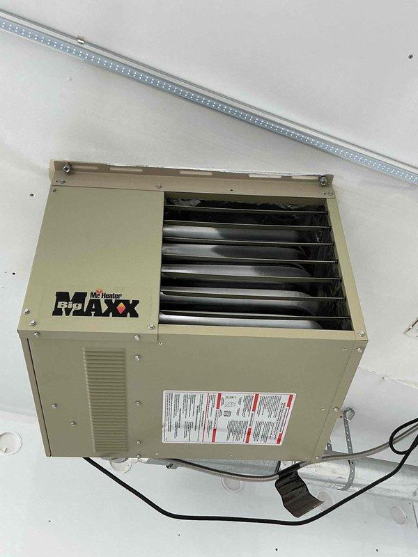 Responded to no heat complaint for garage heater (Mr. Heater MAXX unit). Discovered service switch labeled "Heater off" was in off position. Restored power and verified system operation. Visual inspection via scope revealed significant rust development in heat exchanger. Unable to perform comprehensive inspection due to unit's elevated mounting position and ladder height limitations. All other components functioning normally. Discussed replacement options with homeowner.