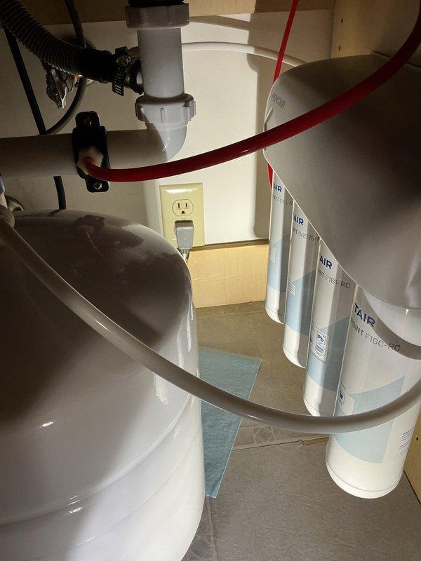 Inspected customer's water treatment system installed less than 12 months ago that was producing cloudy water with visible particulates. Verified filter cartridges require replacement due to sediment buildup. Identified faulty check valve on discharge line and ordered replacement component to prevent backflow issues and improve system performance.
