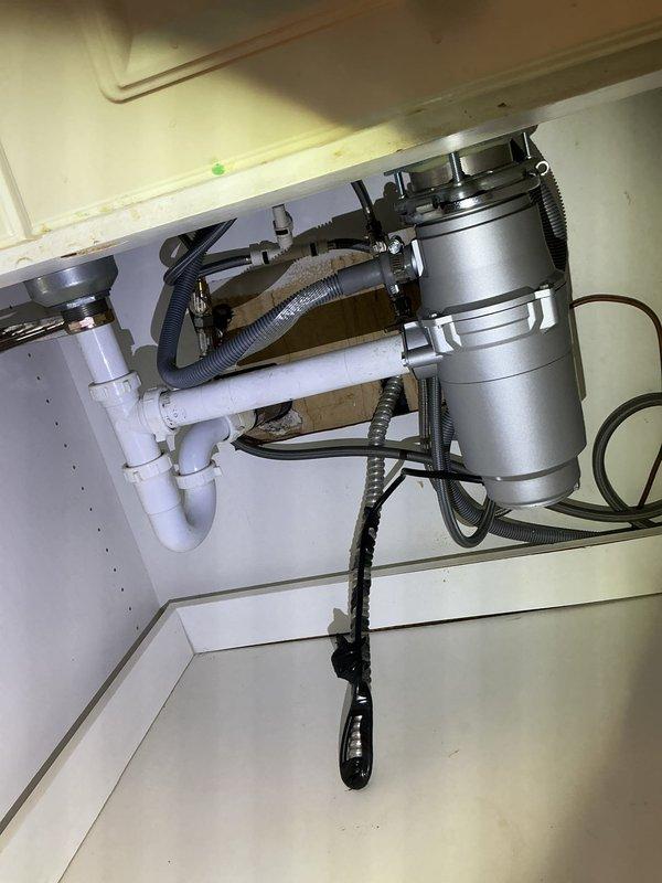 Diagnosed and replaced leaking garbage disposal unit. Removed old disposal that was leaking internally from bottom. Installed new 1/2 HP garbage disposal with proper connections to existing PVC drain system and verified proper operation with no leaks.