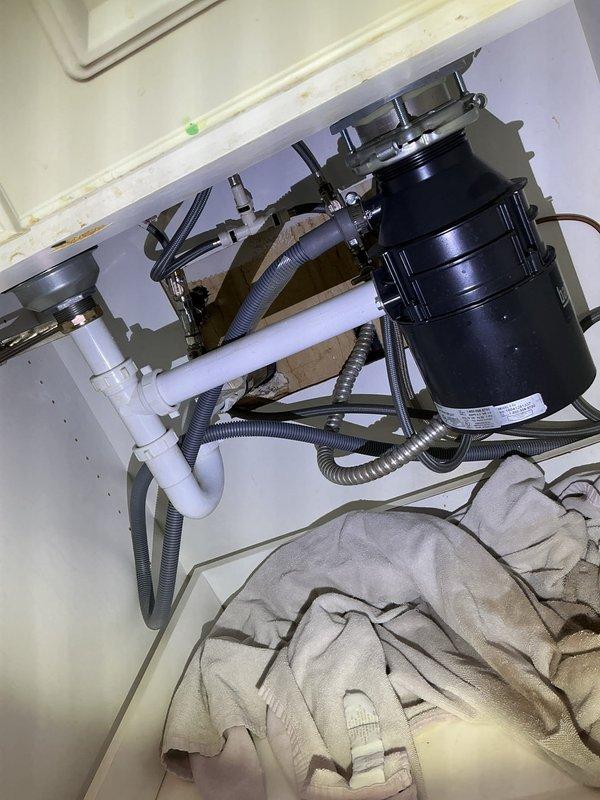 Diagnosed and replaced leaking garbage disposal unit. Removed old disposal that was leaking internally from bottom. Installed new 1/2 HP garbage disposal with proper connections to existing PVC drain system and verified proper operation with no leaks.