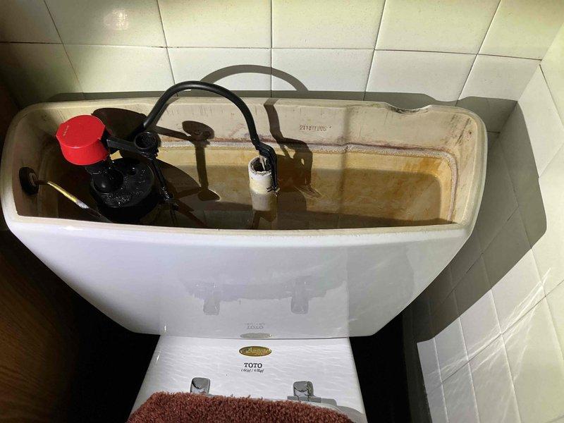 Responded to service call for toilet issues. Diagnosed faulty fill valve causing improper tank filling as evidenced by stained water and mineral buildup. Removed old fill valve assembly and installed new replacement unit to restore proper toilet operation.