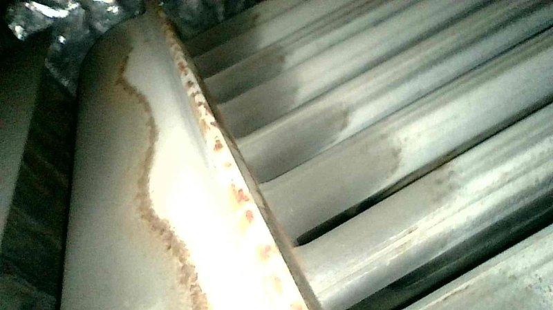 Performed comprehensive maintenance on two older Ruud furnaces. Both units operating correctly for their age with no current issues. Noted galvanized flaking on upstairs unit's heat exchanger (no holes present) and documented visible corrosion along metal seams with photos. Replaced batteries in downstairs thermostat displaying low battery warning and recommended filter replacement for both systems.