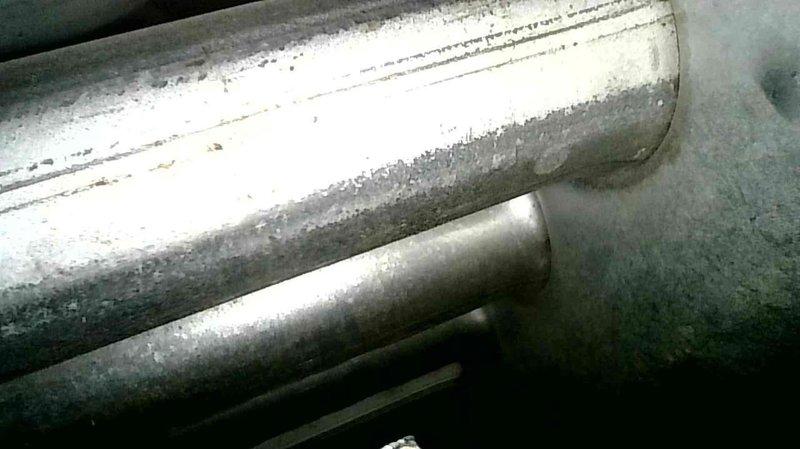 Performed comprehensive maintenance on two older Ruud furnaces. Both units operating correctly for their age with no current issues. Noted galvanized flaking on upstairs unit's heat exchanger (no holes present) and documented visible corrosion along metal seams with photos. Replaced batteries in downstairs thermostat displaying low battery warning and recommended filter replacement for both systems.