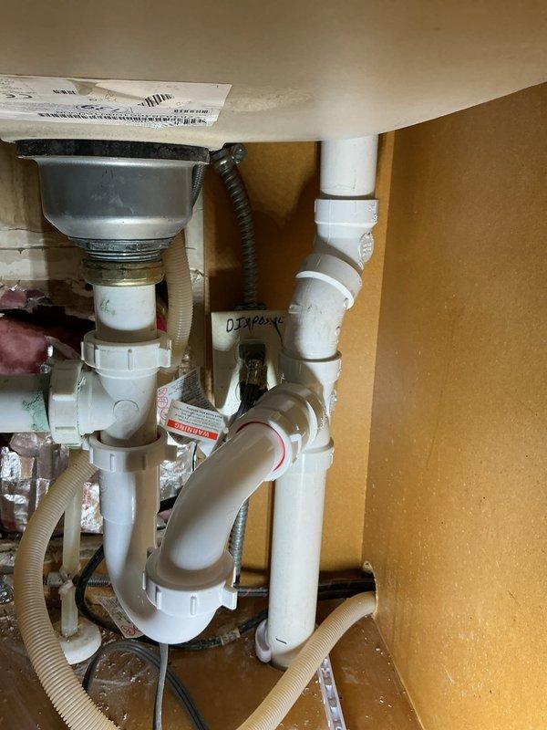 Identified and repaired a non-code-compliant PVC leak underneath the kitchen sink. Repiped both upper and lower portions of the kitchen sink drainage system, installing proper P-trap assembly and ensuring all connections meet current code requirements for improved compliance and functionality.