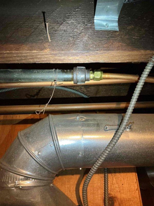 Responded to a gas leak service request. Located leak at black iron to copper adapter fitting, which was previously identified by the gas company. Verified leak with bubble test, completed repair, and pressure tested both the repaired fitting and adjacent copper flare fitting to confirm integrity. Service included restoring gas supply and relighting water heater pilot.