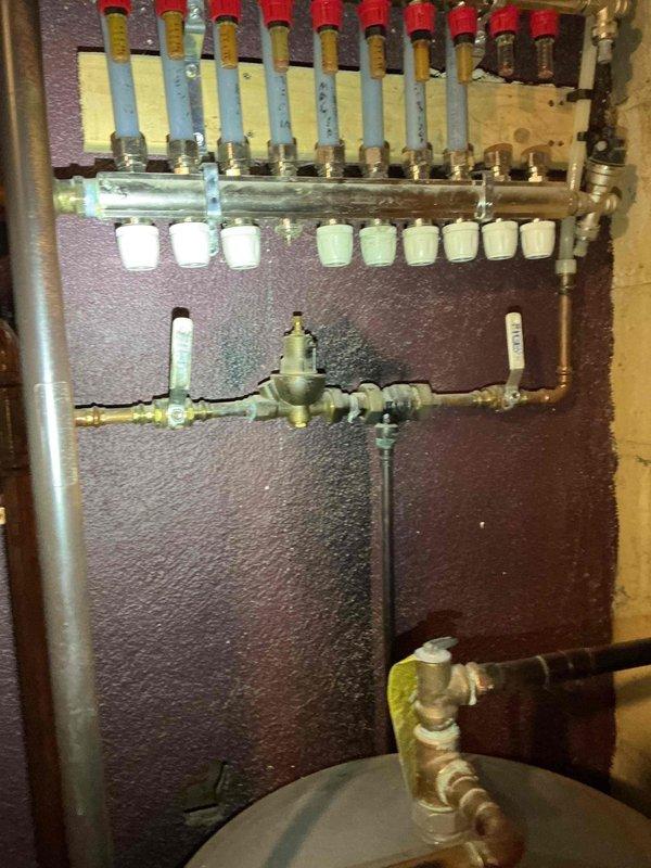 Responded to no heat complaint on Triangle Tube boiler. Discovered bleeder valve had dislodged from radiator causing system pressure drop to zero. Restored functionality by securing bleeder valve and repressurizing system to 16 PSI, restoring heat to majority of radiators. Identified two non-functioning radiators (basement and top floor) despite proper bleeding and open valves; likely sediment-related issue requiring system flush.